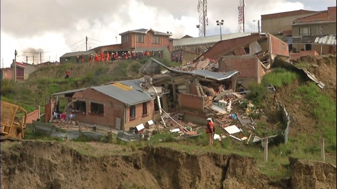 Homes collapse down hill in landslide
