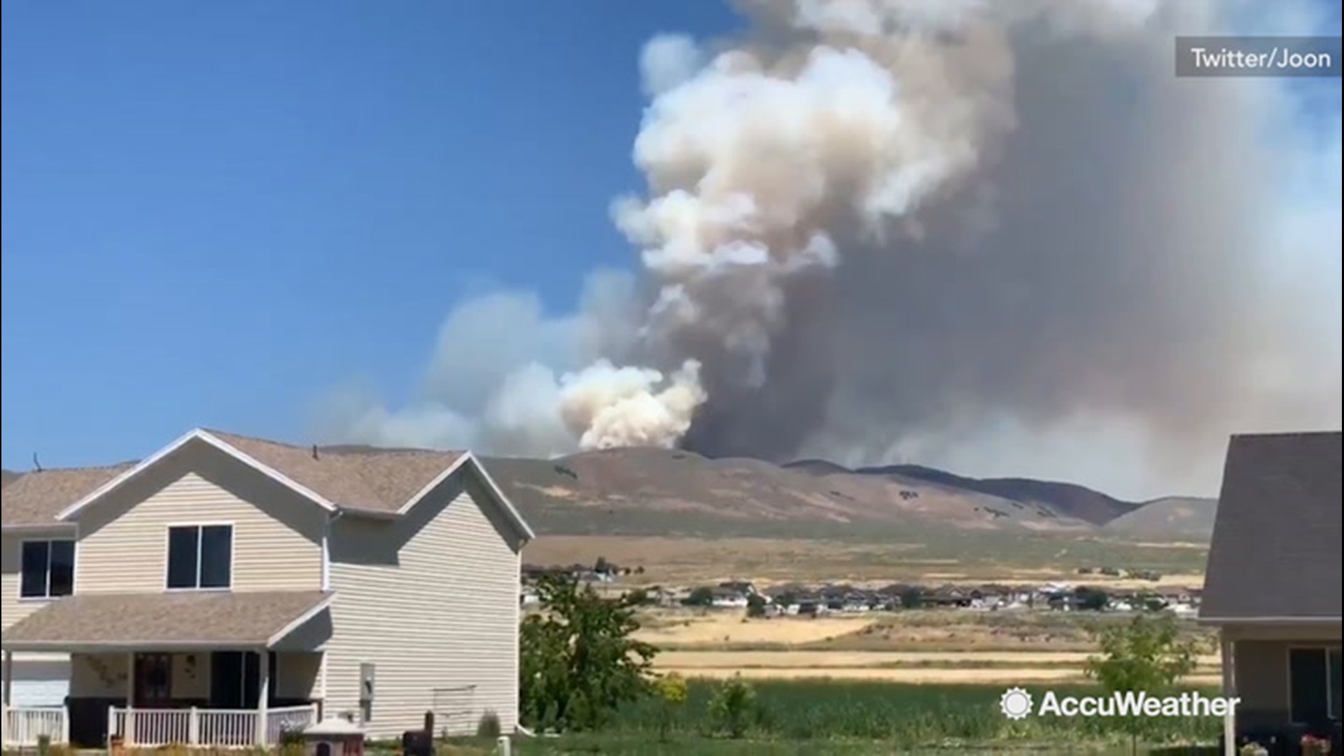 Residents watch from their house as the Radio Hill fire burns near Tremonton, Utah, on July 15.