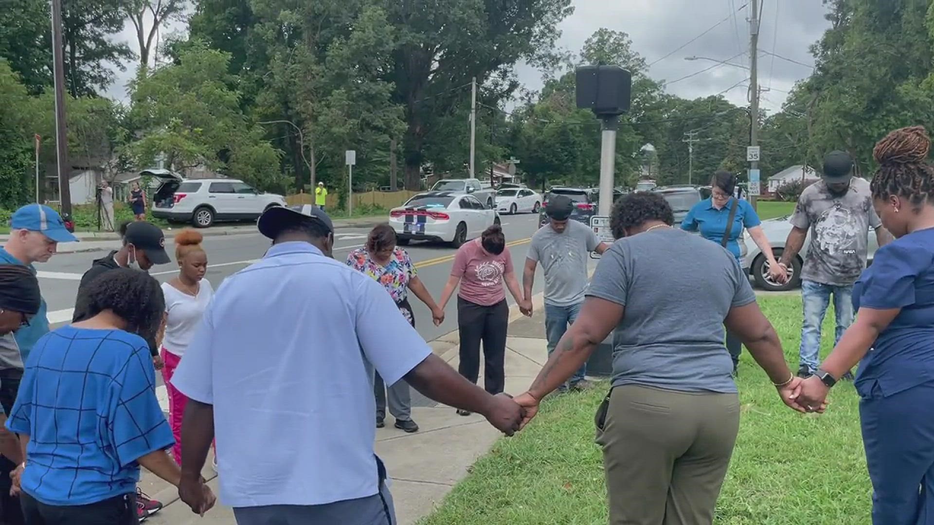 Parents and neighbors formed a prayer circle to pray for students and teachers after a shooting at Mount Tabor High School.