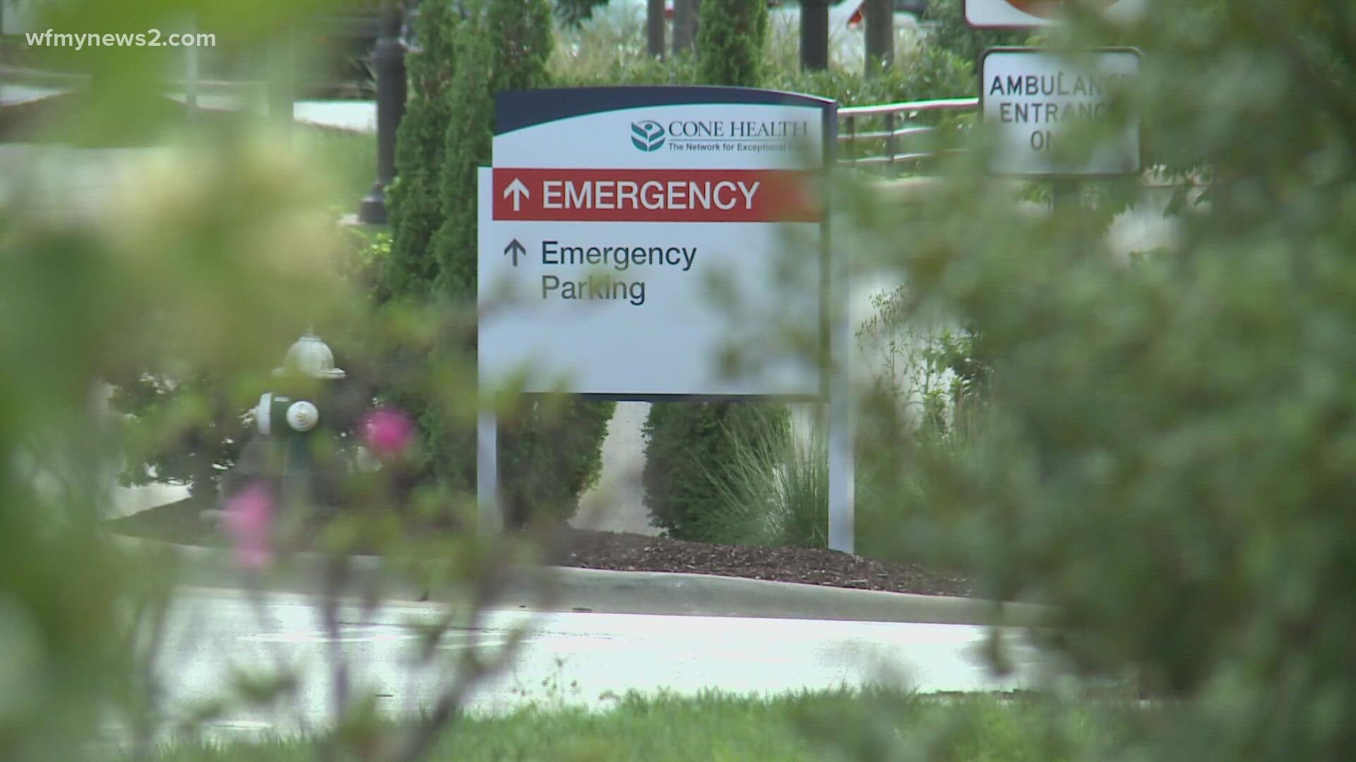 Cone Health says longer wait times are because of a surge in COVID-19-positive patients and a staffing shortage.