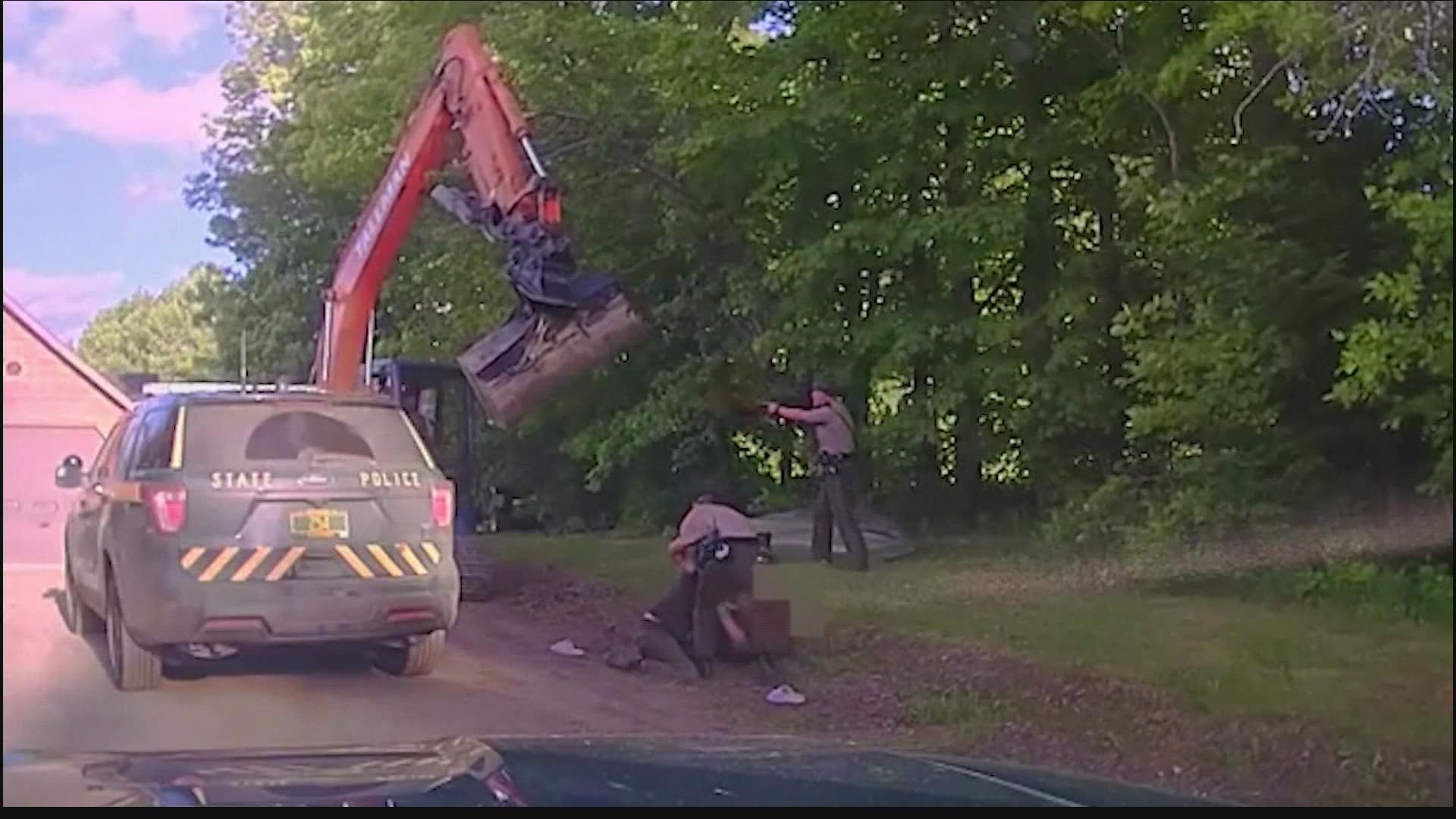 Vermont troopers showed up to take a man into custody when his dad tried to wack officials with the excavator.