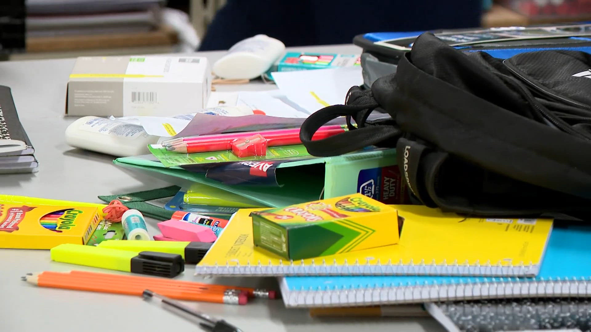 Volunteers fill backpacks with essential school supplies for students in need