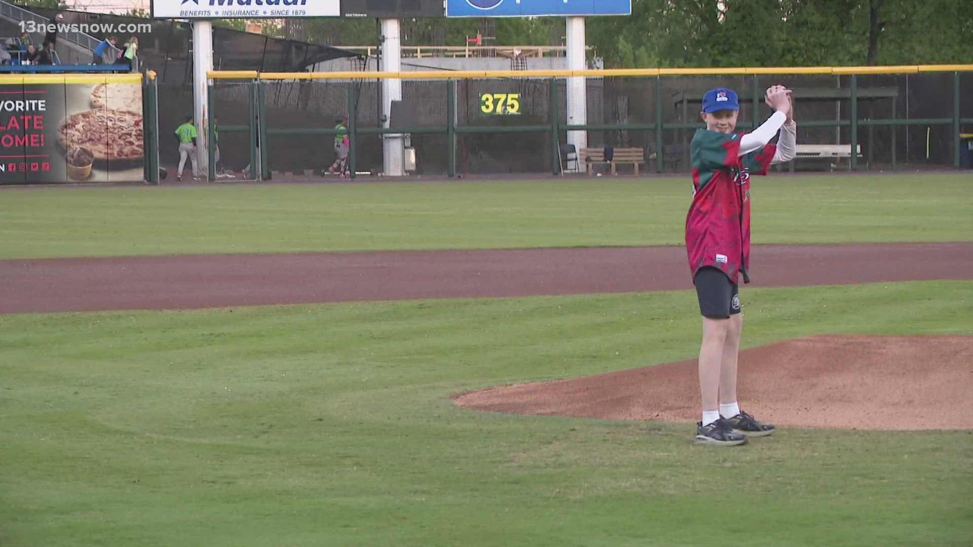 Young cancer survivor throws emotional first pitch at Harbor Park in ...