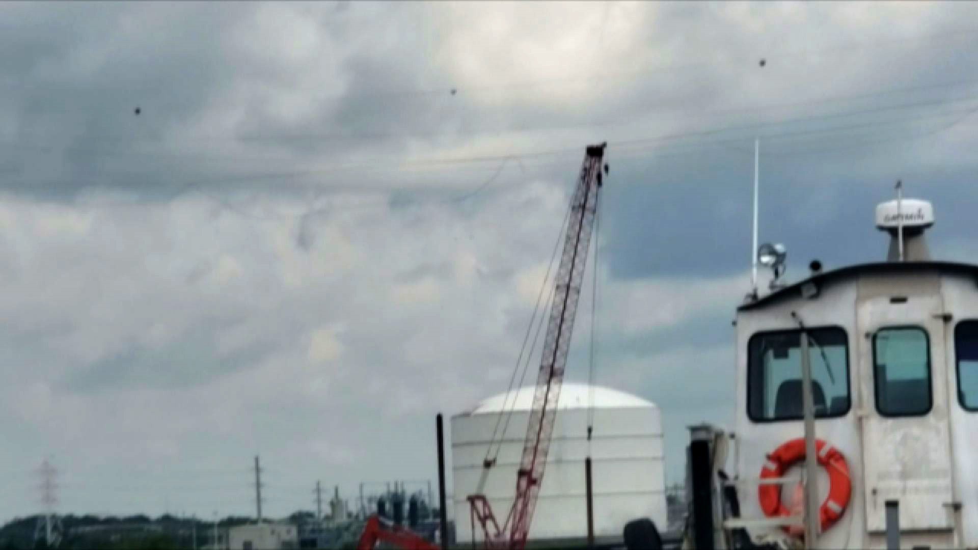 Cell phone video captures the moment a crane on a barge hits and knocks down power lines while going down the Elizabeth River, causing widespread outages in Chesapeake and Virginia Beach.