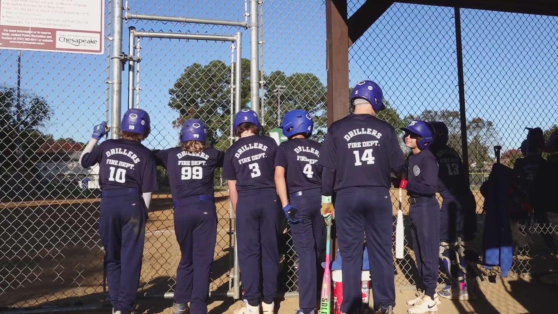 Youth baseball team dons firefighter costumes for "Field of Screams" event.