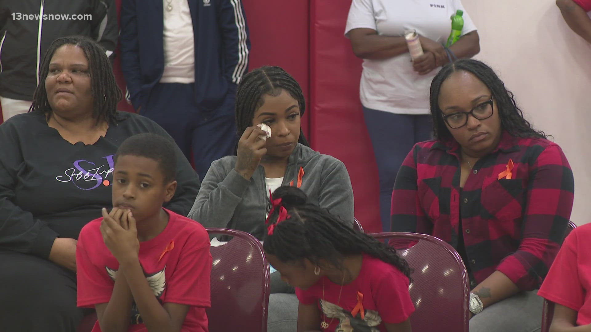 The community came together for a candlelight vigil in Suffolk after a shooting left two men dead and three others hurt.