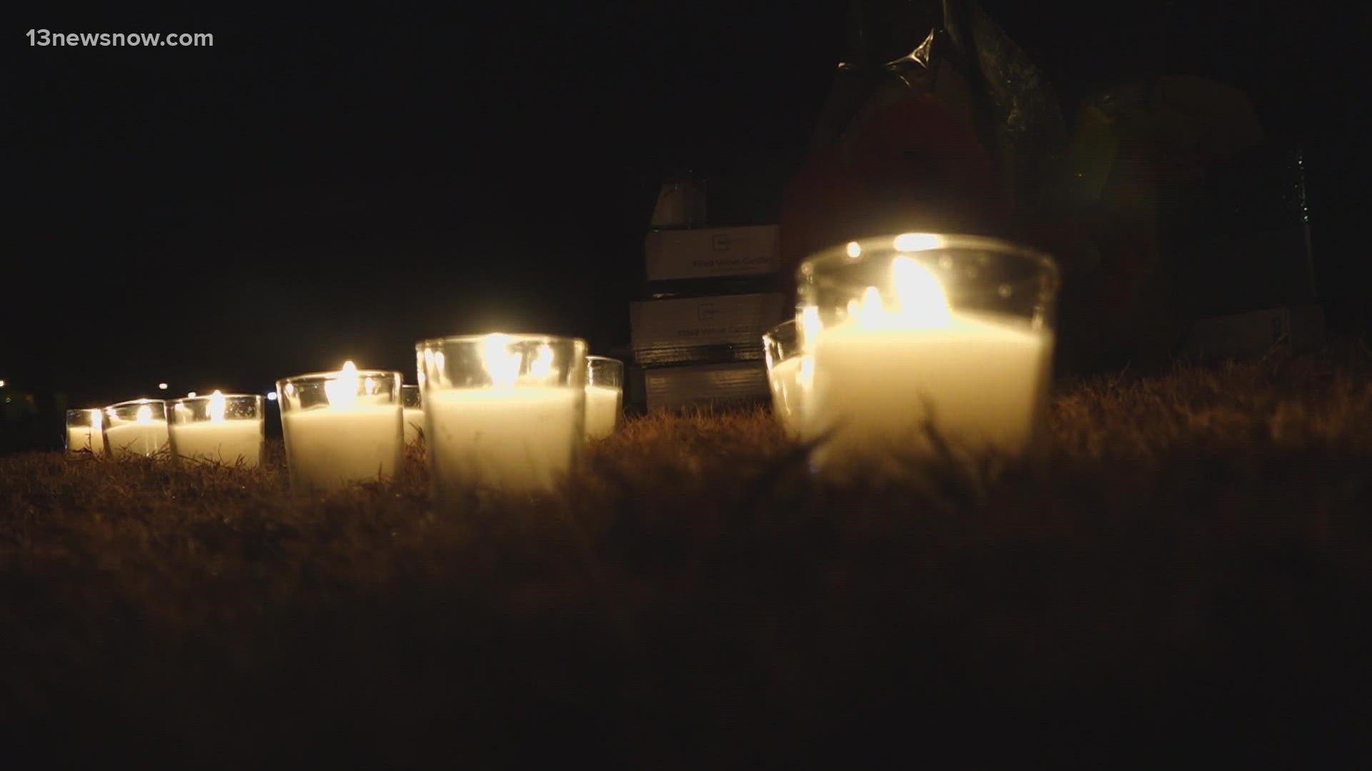 Buses full of people walked onto a field lit with candles to honor and remember the lives lost in the Walmart mass shooting - each with their own story.