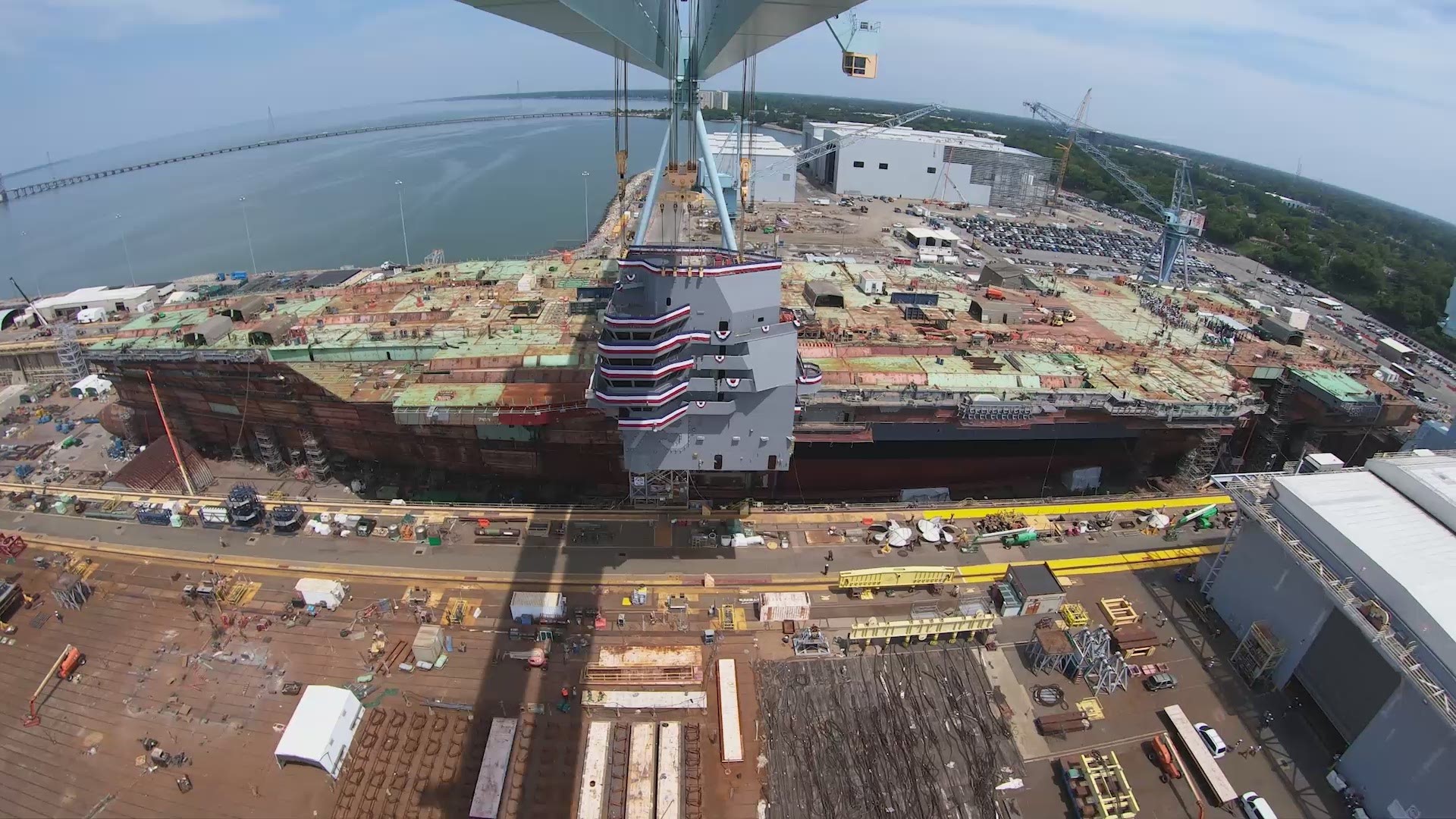 Newport News Shipbuilding adds the island onto the future USS John F. Kennedy. The island gives the ship the distinctive profile of an aircraft carrier.