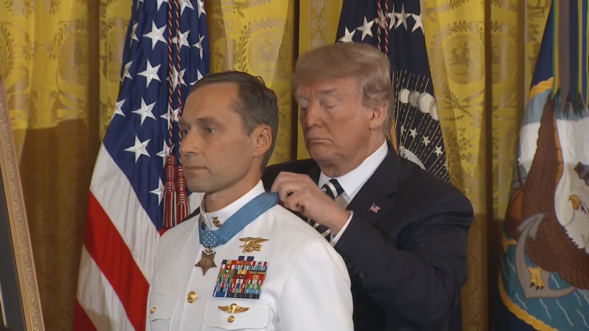 President Donald Trump awards the Medal of Honor to a Navy SEAL who oversaw a daring assault and rescue mission on a snowy Afghanistan mountaintop in 2002.