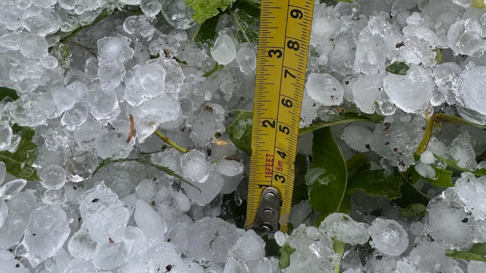 Hail blankets a backyard in the Hunt Club neighborhood of Virginia Beach after a severe thunderstorm, Friday, May 9, 2025.