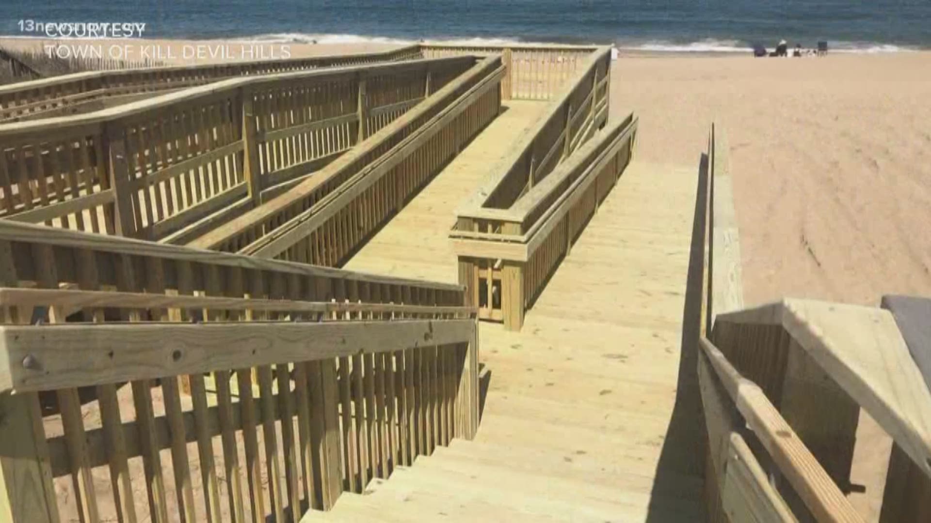 A wooden ramp and roll out mats will help people in wheelchairs in Kill Devil Hills to get from the parking lot to the water line.