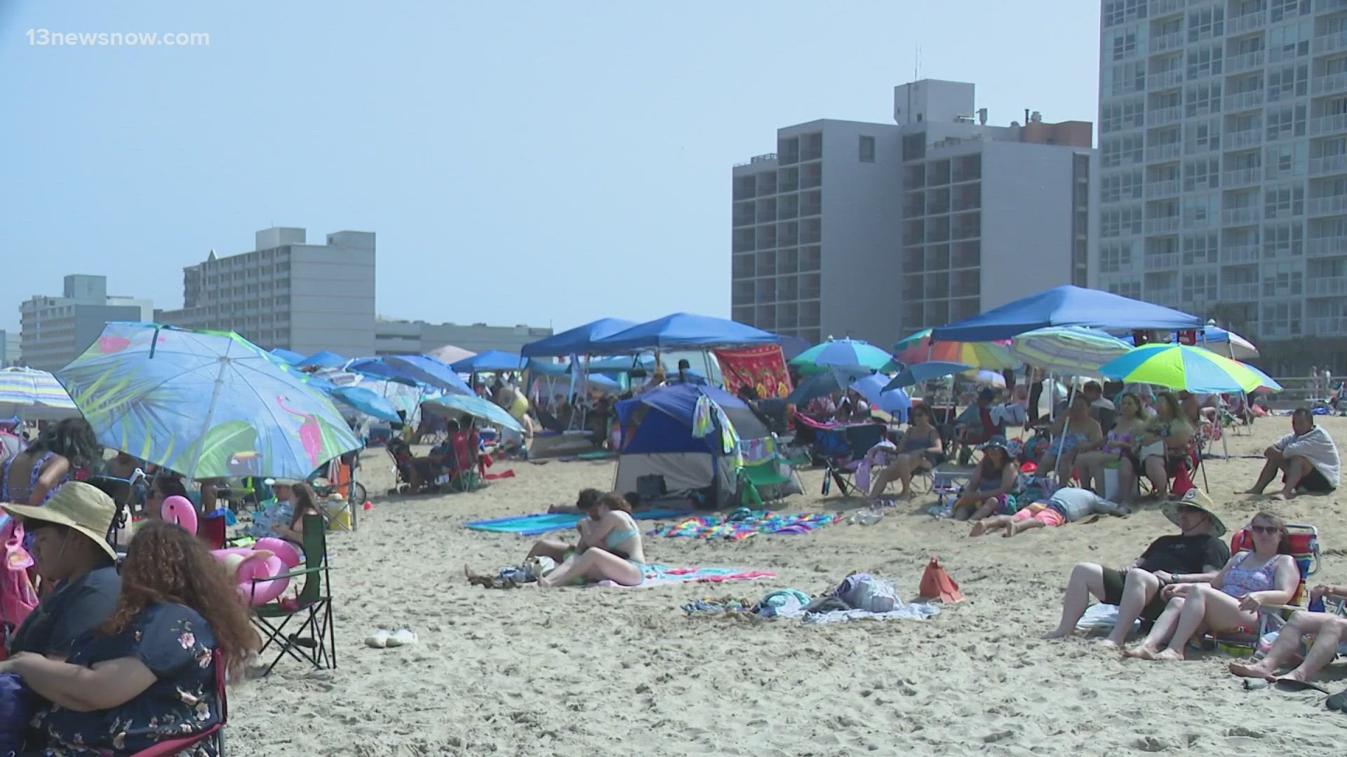 Although there were red flags flying, signifying the presence of rip tides, the beach was jammed with revelers.