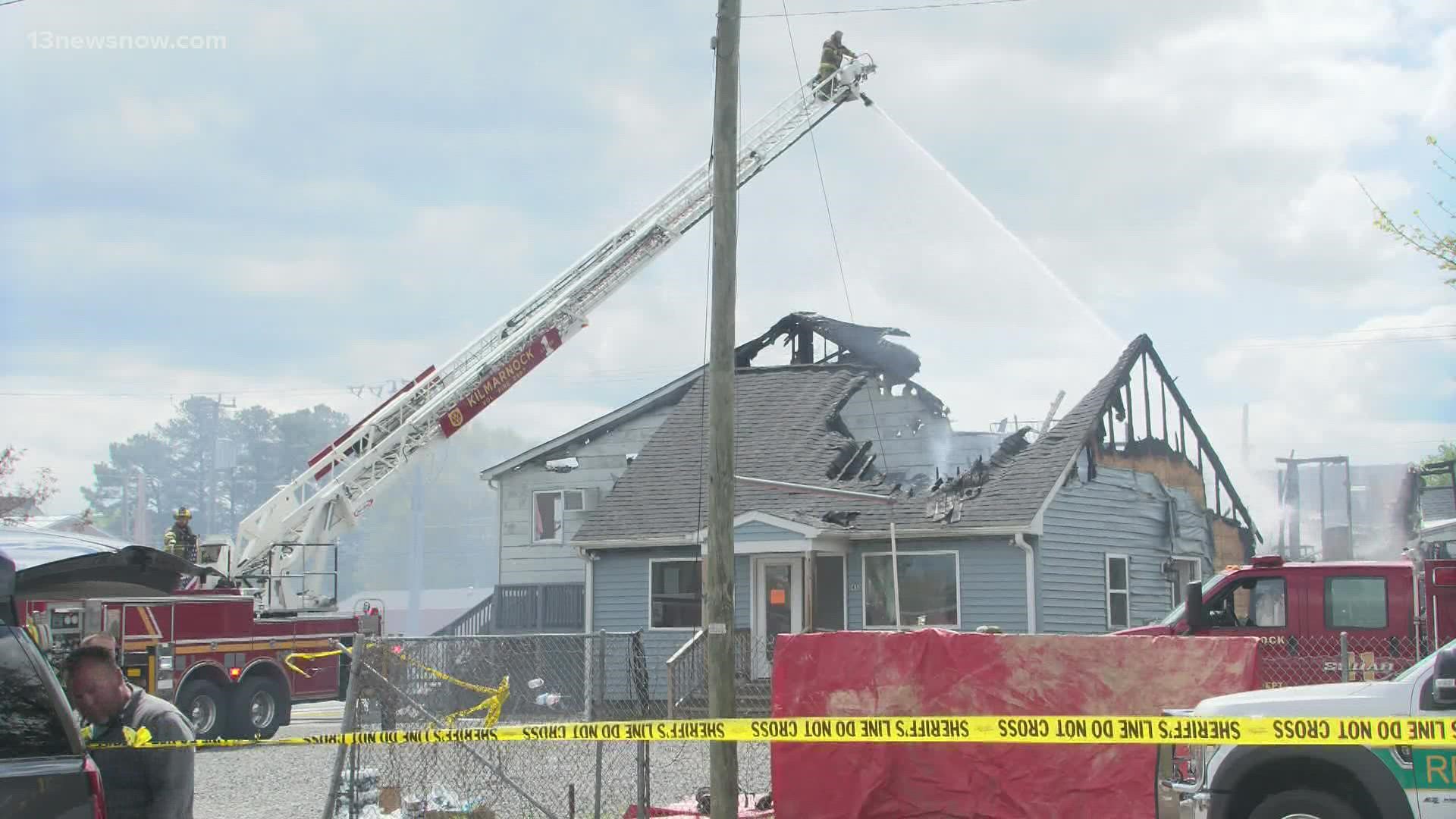 Crews say strong winds caused the fire that killed one person and spread to six apartment units and several nearby businesses on Tuesday.