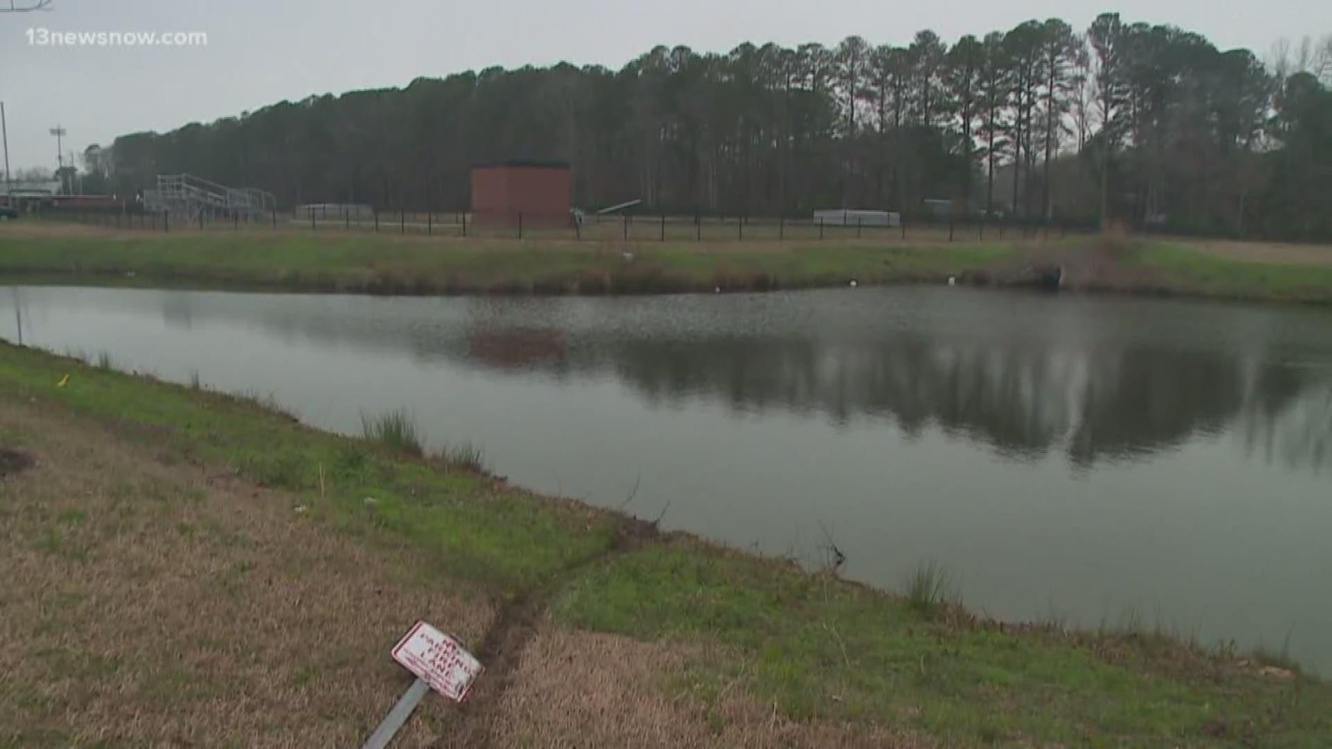 The person was driving when the car hit a stop sign. She overcorrected and the car went into a pond. She's OK.