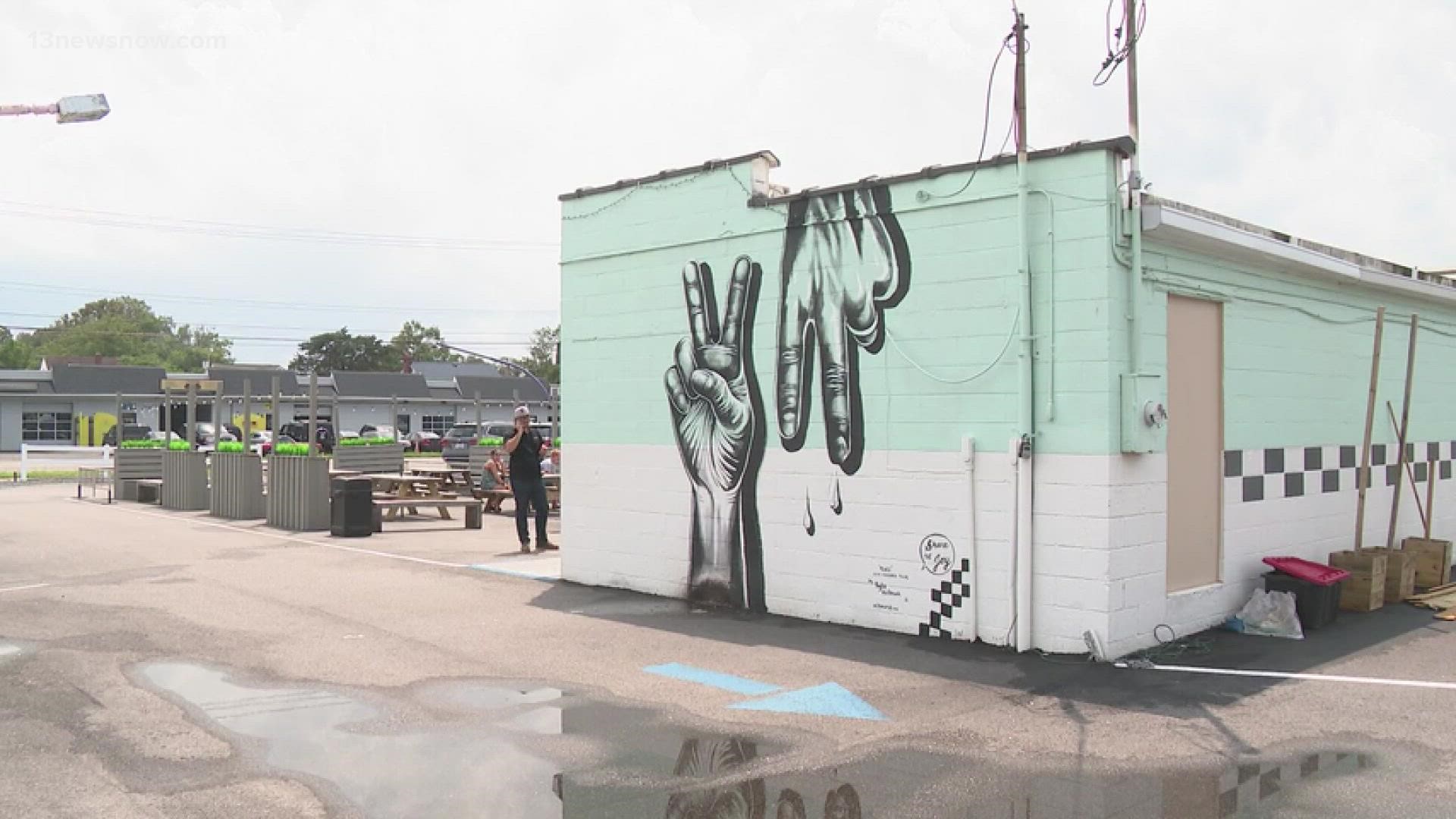 Kyle Holbrook painted the "Peace Virginia" mural on the side of Lolly's Creamery in the ViBe District.