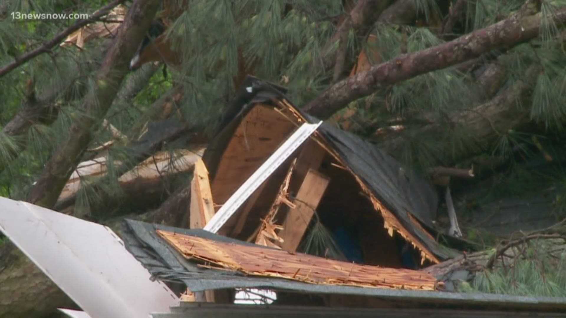 An EF-1 tornado tore through a Suffolk neighborhood Saturday. At least one family is displaced after trees crashed through their roof while others also work on cleaning up.