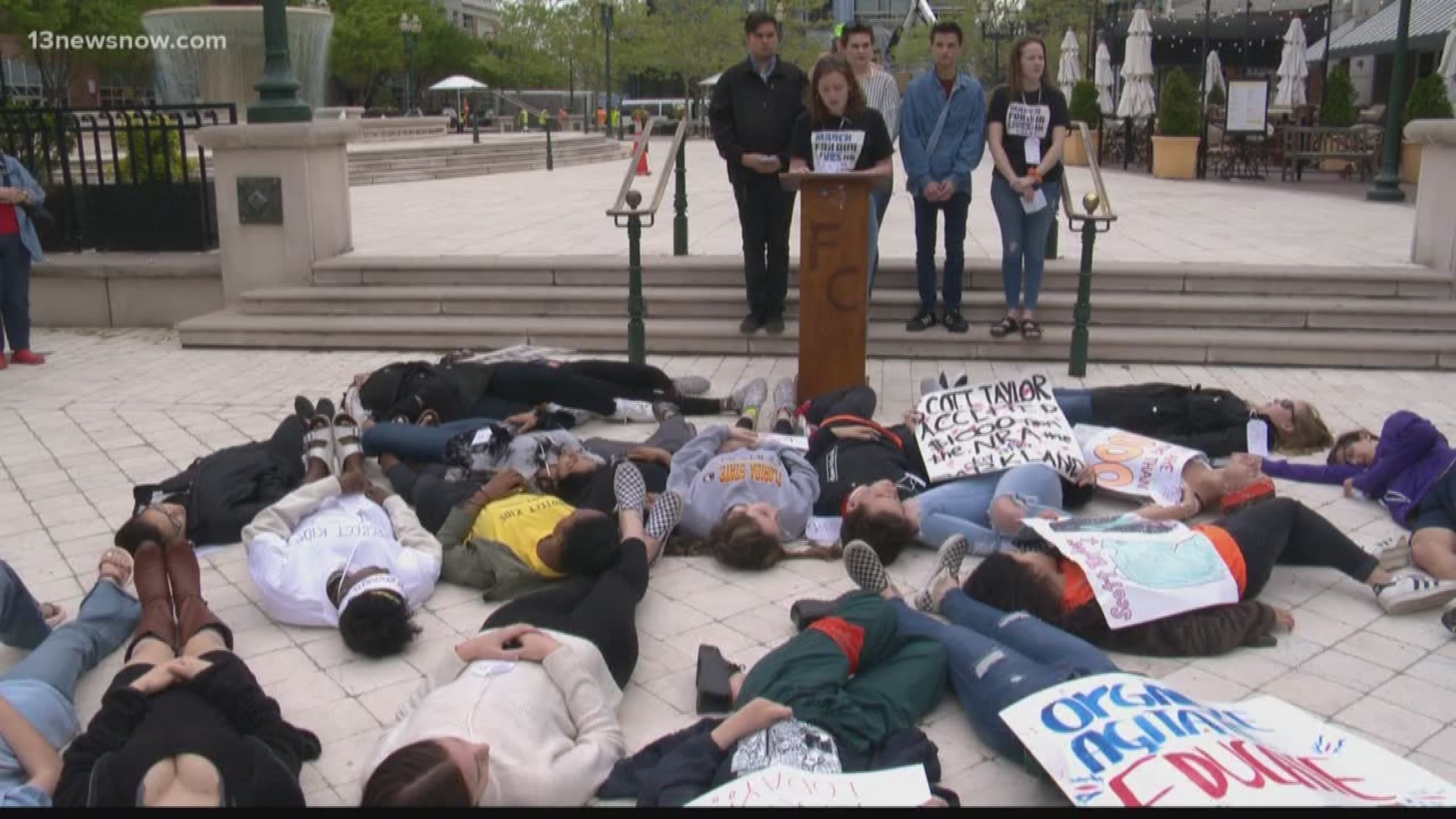 Dozens of students gathered to stage a "die-in" protest at the Virginia Beach Town Center to fight for stricter gun control laws.