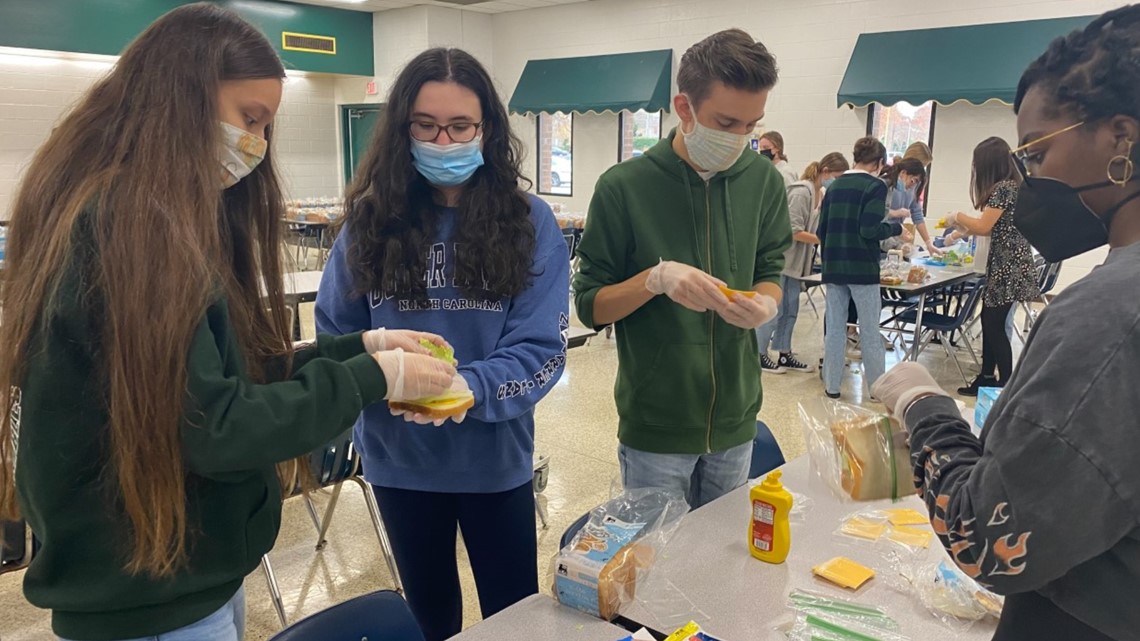 Cox High School students pack sandwiches for those in need