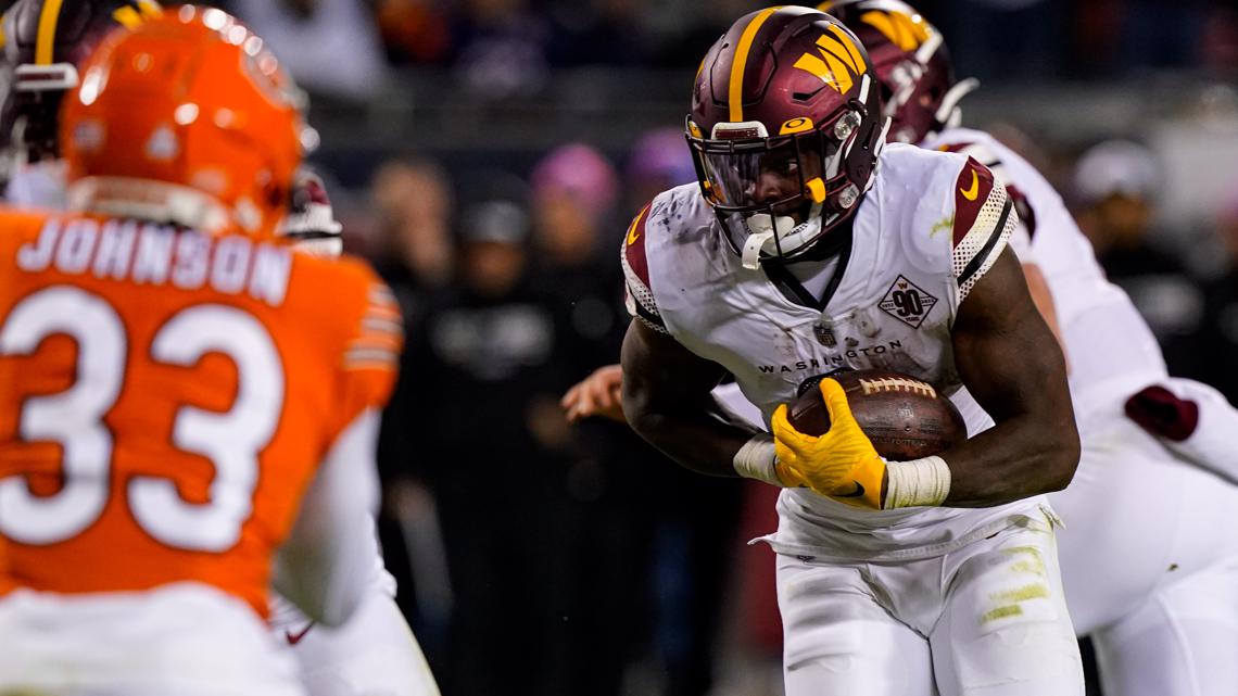 Chicago Bears quarterback Justin Fields runs against the Washington  Commanders in the second half of an NFL football game in Chicago, Thursday,  Oct. 13, 2022. The Commanders defeated the Bears 12-7. (AP