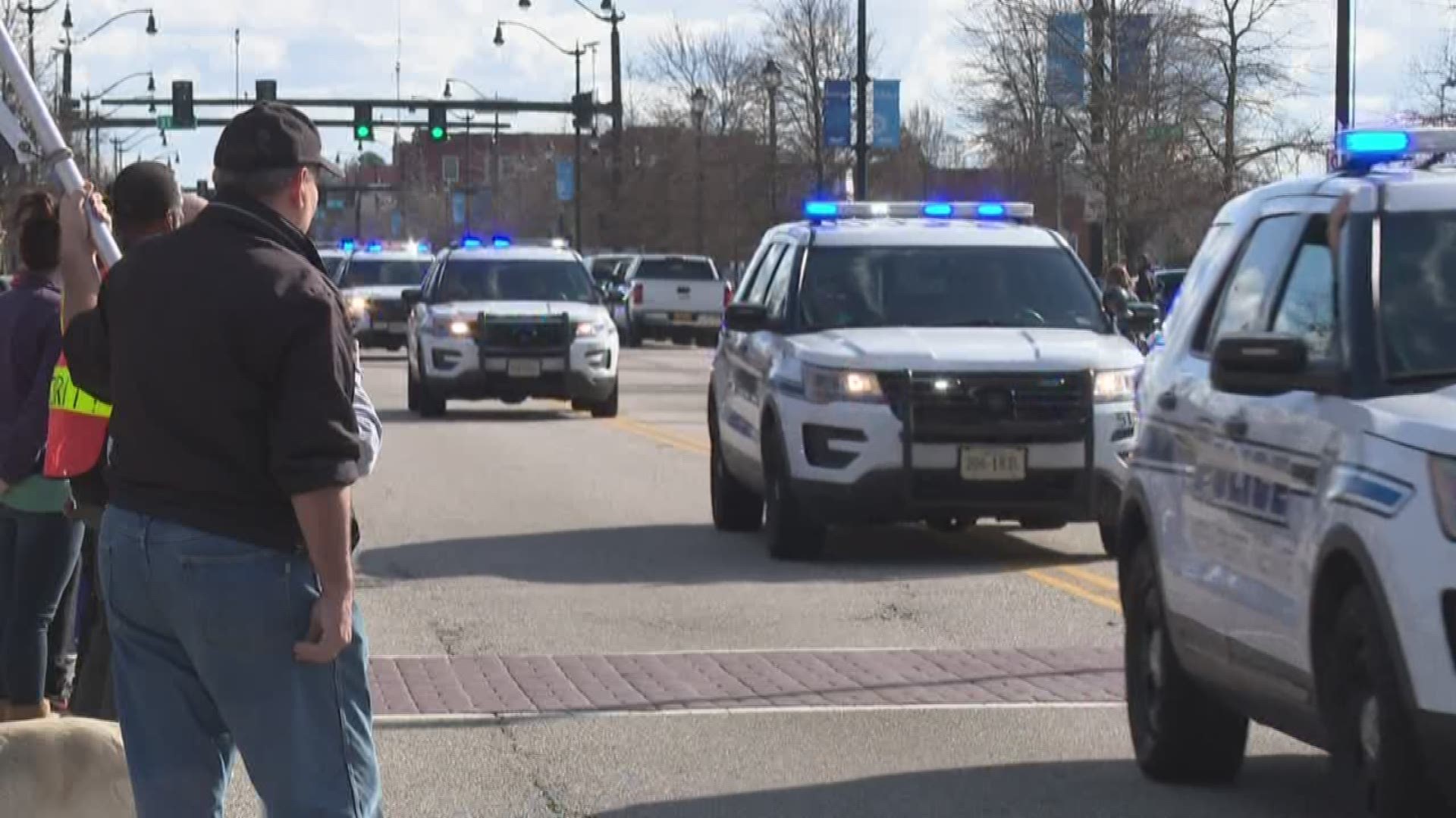 Law enforcement and community members waited along the procession's route to pay respects to Officer Katie Thyne, who was killed in the line of duty.