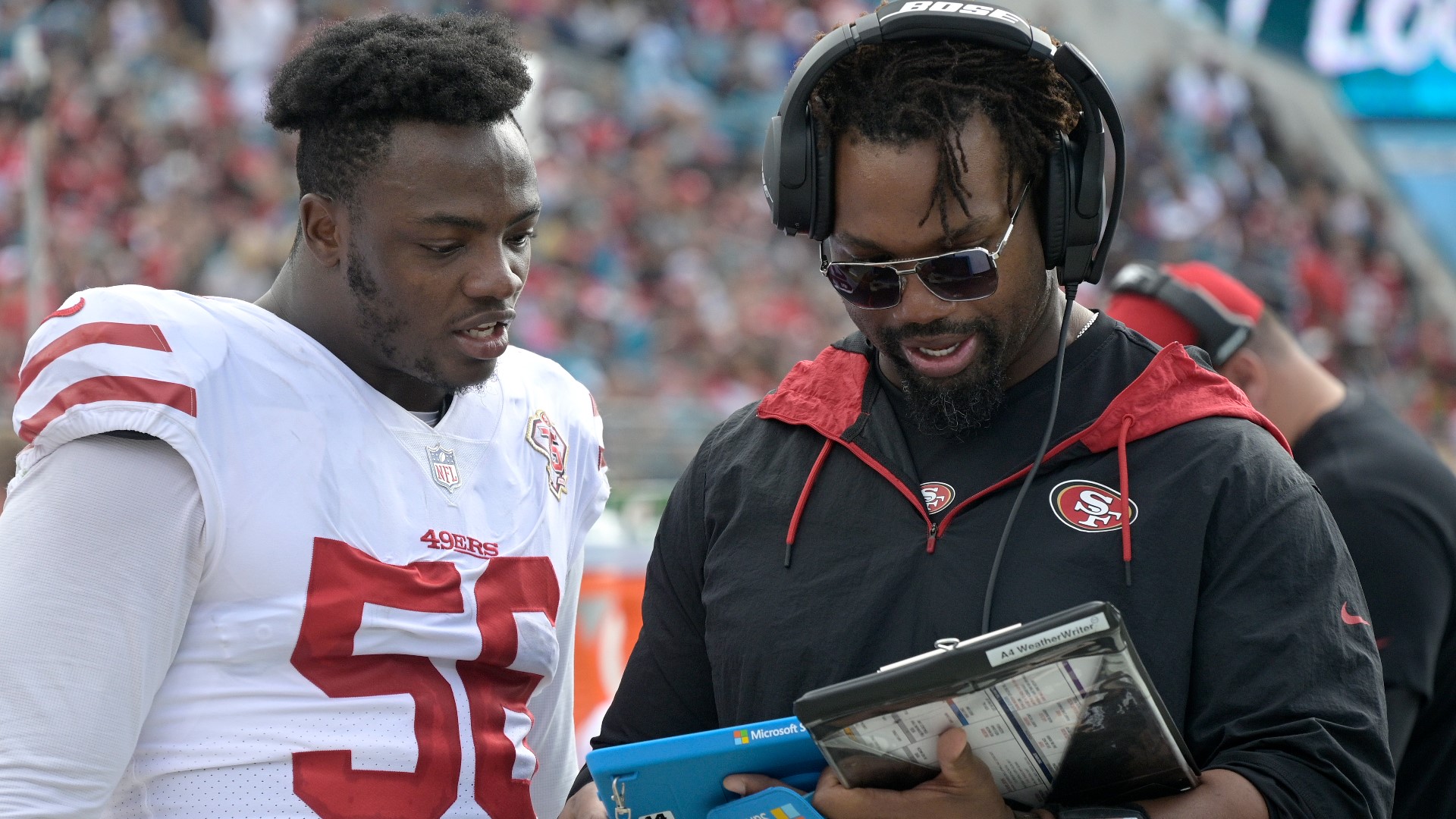 San Francisco 49ers assistant defensive line coach Darryl Tapp (right) Sunday, Nov. 21, 2021, in Jacksonville, Fla. (AP Photo/Phelan M. Ebenhack)