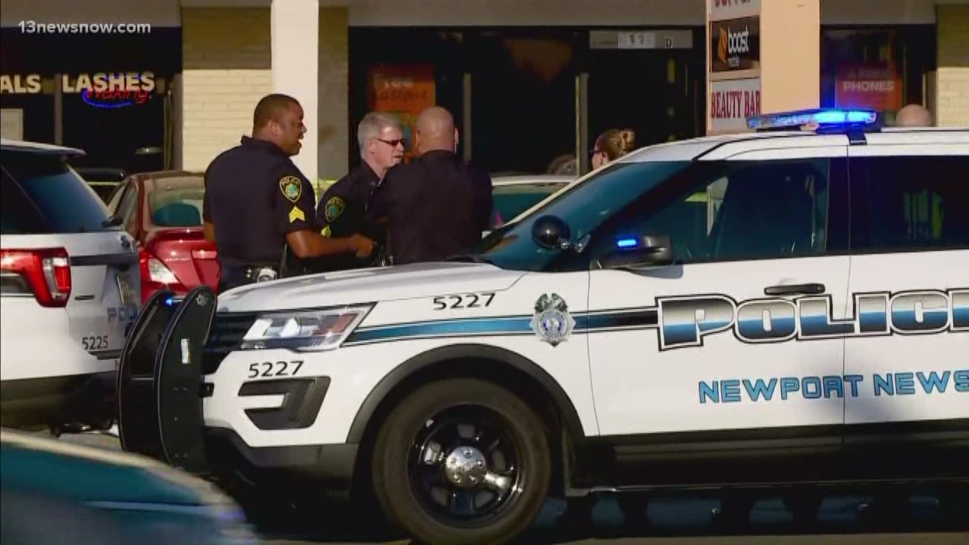 The woman was shot outside of the Boost Mobile store on Jefferson Avenue.