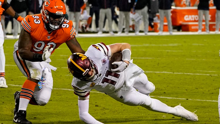 Chicago Bears quarterback Justin Fields runs against the Washington  Commanders in the second half of an NFL football game in Chicago, Thursday,  Oct. 13, 2022. The Commanders defeated the Bears 12-7. (AP