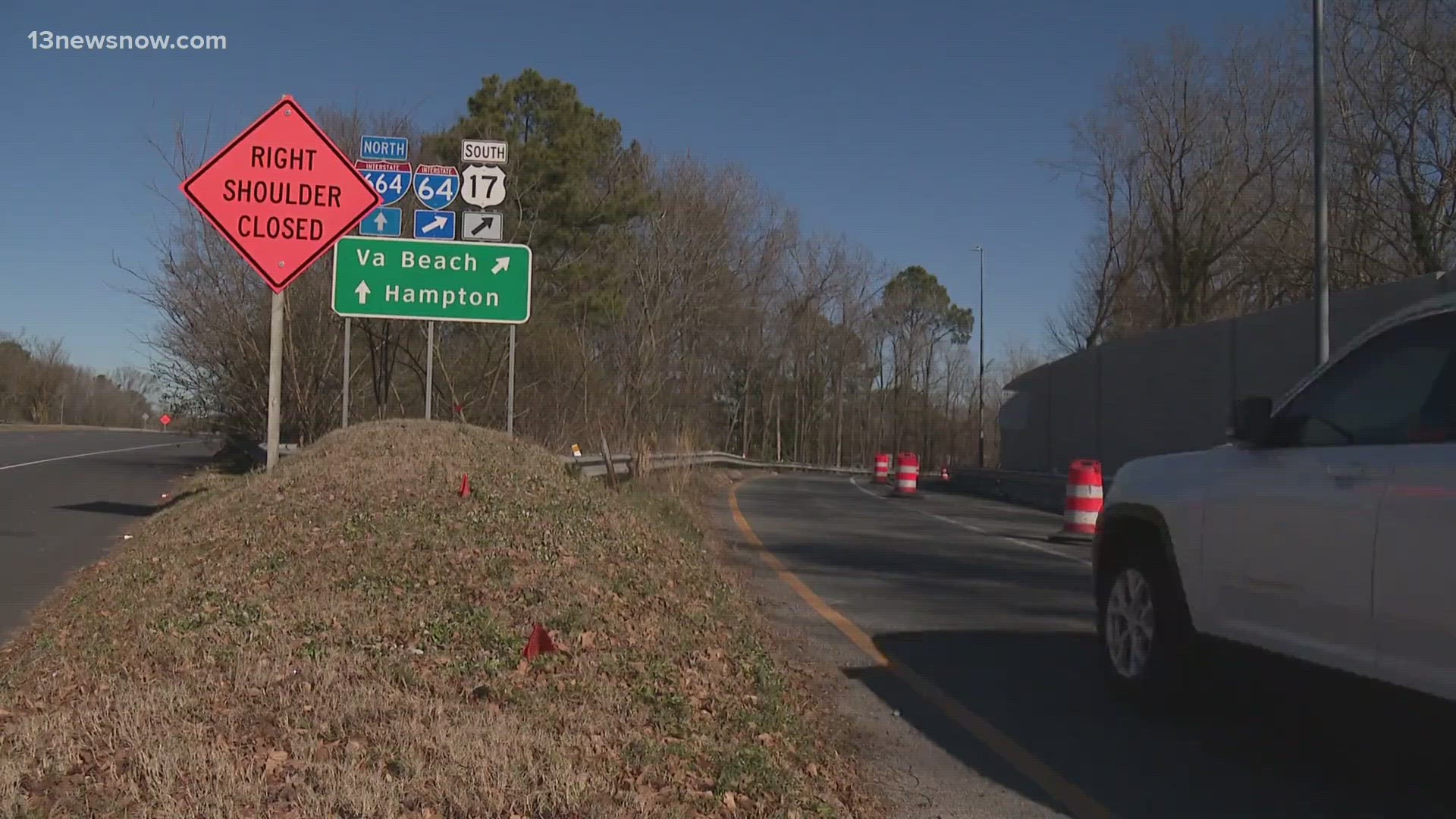 The new signage, pavement markings and white posts are part of the installation of new HOV express lanes.