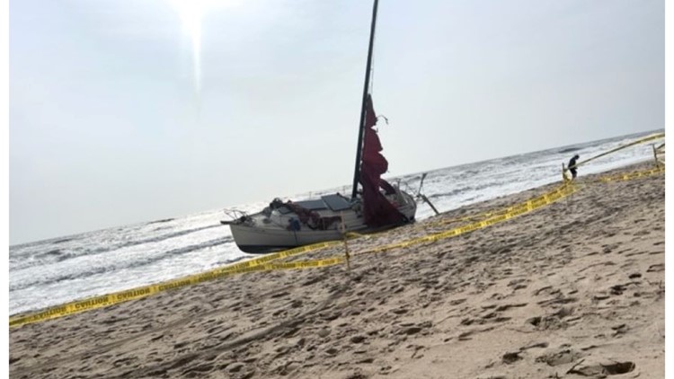 Nags Head police work to get sailboat off of beach shore