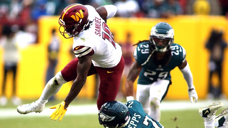 Washington Commanders running back J.D. McKissic (23) is tripped up by  Philadelphia Eagles linebacker Kyzir White (43) during the second half of  an NFL football game, Sunday, Sept. 25, 2022, in Landover