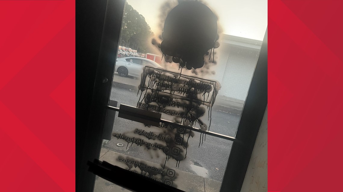 Masked vandals spray paint Newport News tattoo shop