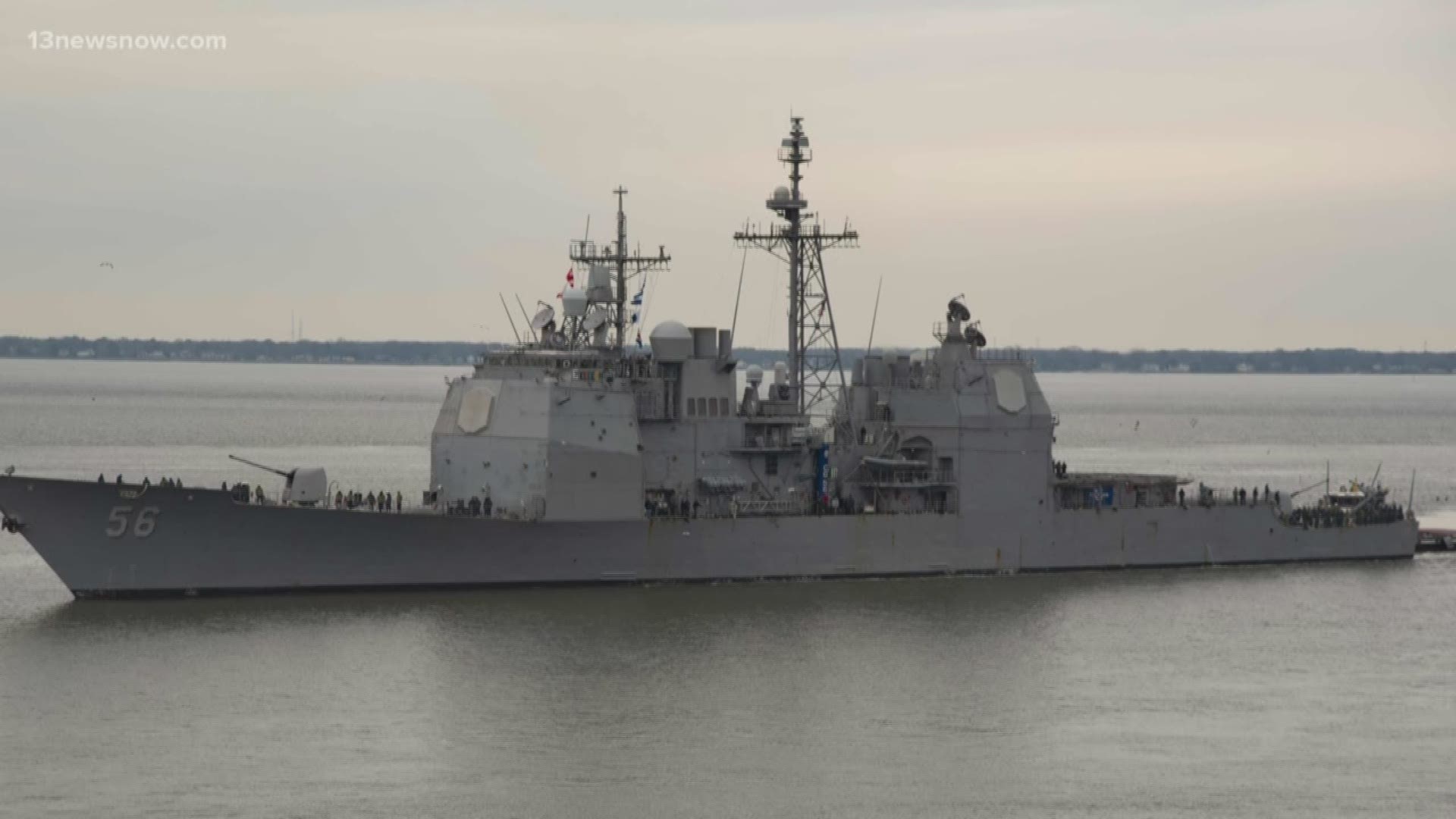 The guided-missile cruiser was in port at Naval Station Norfolk when the worker died.