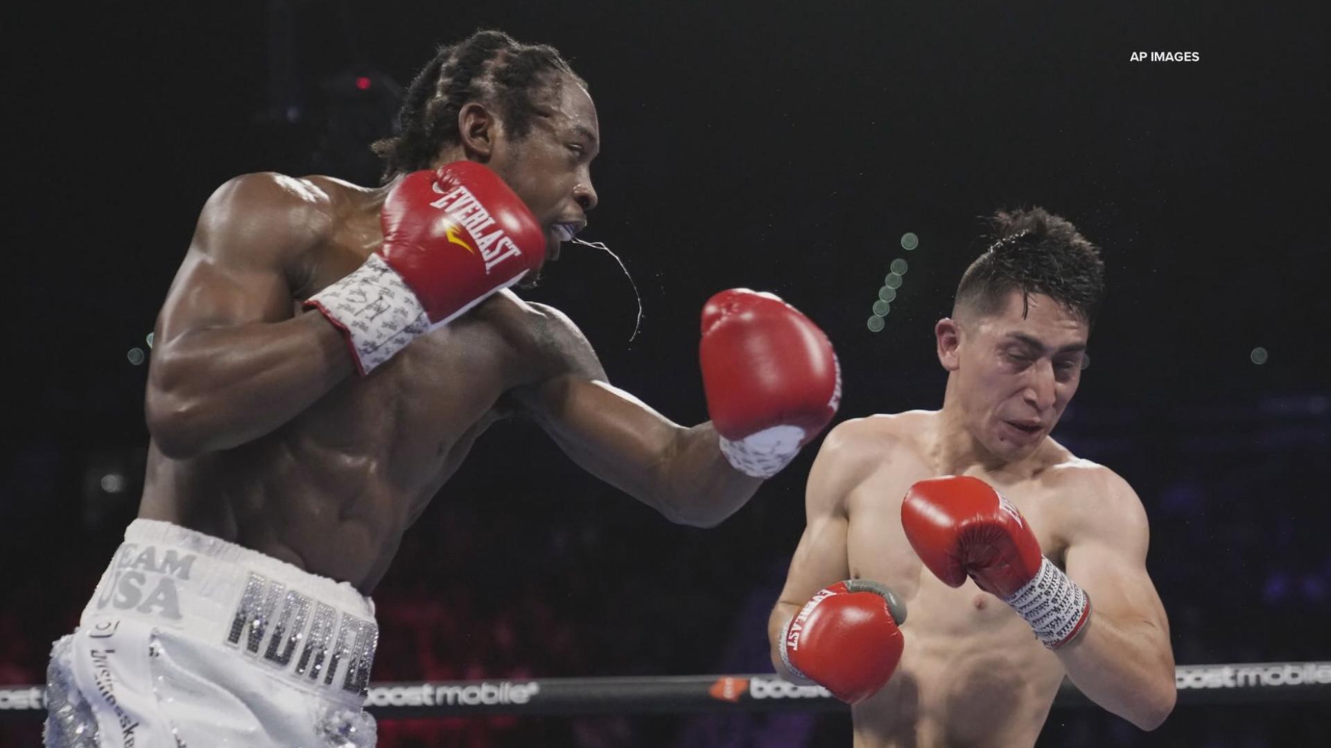 Keyshawn Davis punches Esteban Sanchez during a lightweight boxing bout Saturday, April 30, 2022, in Las Vegas.