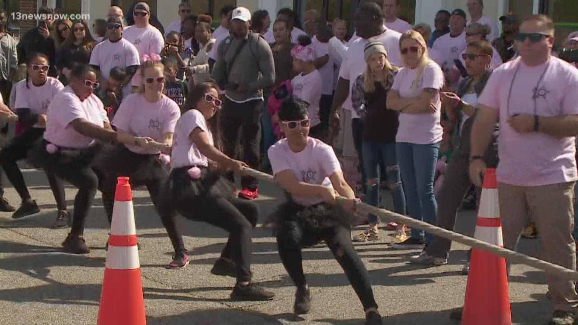 Teams of eight compete to see which team can pull a fire truck 12 feet in the fastest time. The event is in support of the fight against breast cancer.