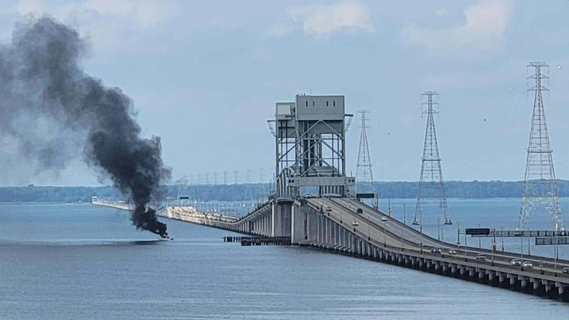 Fire-rescue crews work to put out flames on a recreational boat near the James River Bridge Sunday morning, Aug. 11, 2024.